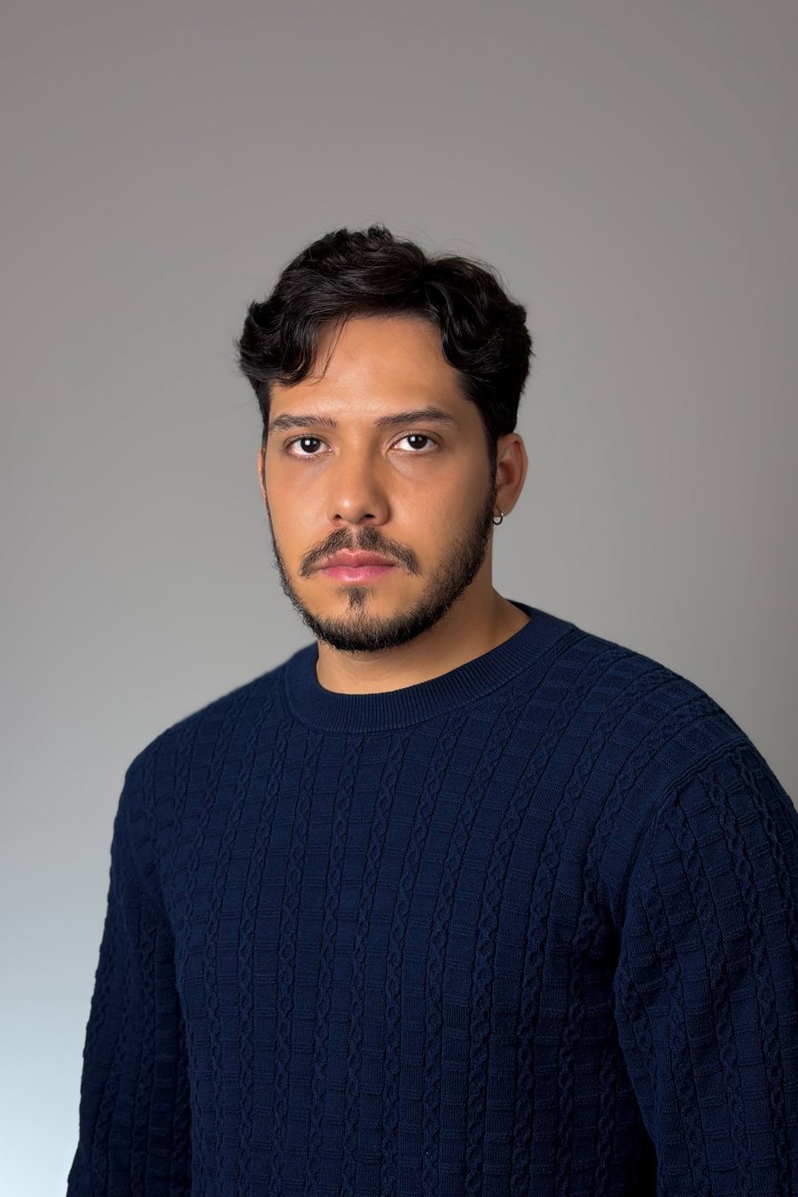 Bruno DiSanto, studio portrait in a navy sweater